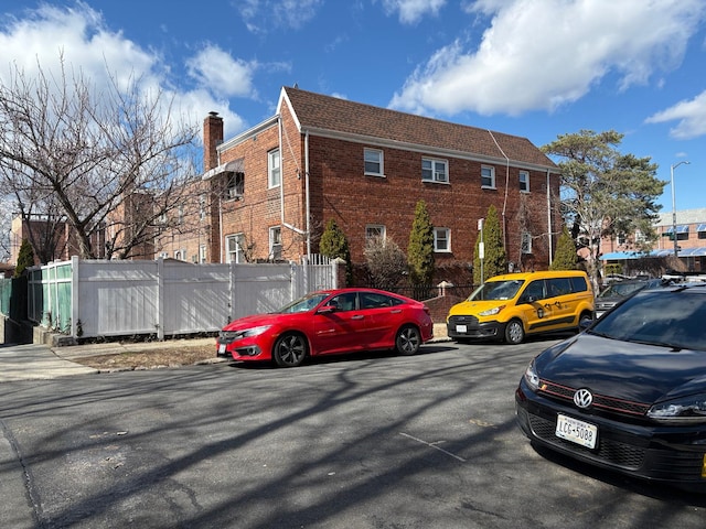 view of parking featuring fence