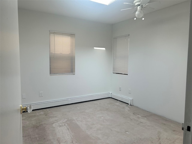 unfurnished room with carpet floors, ceiling fan, and a baseboard heating unit