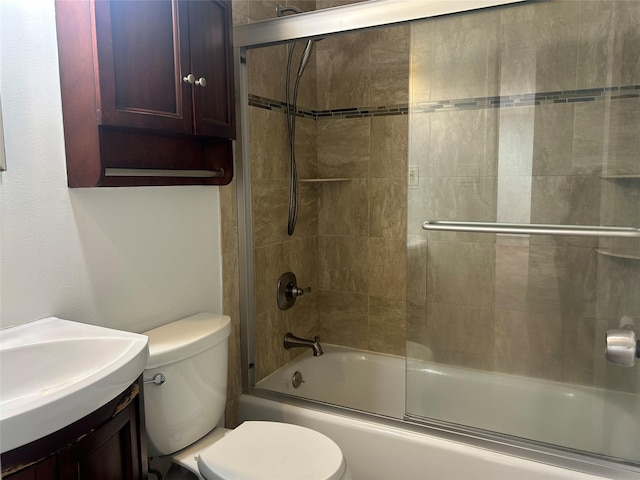 bathroom featuring vanity, toilet, and bath / shower combo with glass door