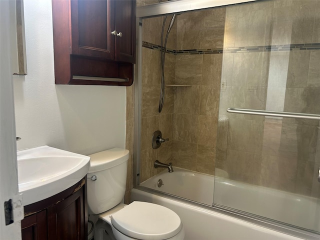 full bathroom with vanity, toilet, and combined bath / shower with glass door