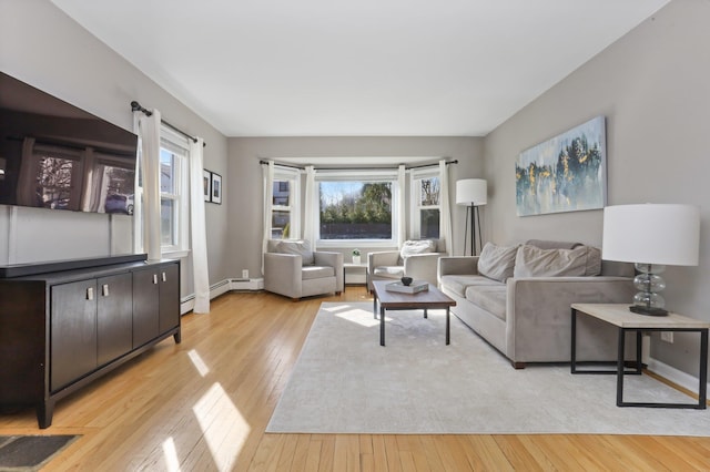 living room featuring baseboards and light wood finished floors