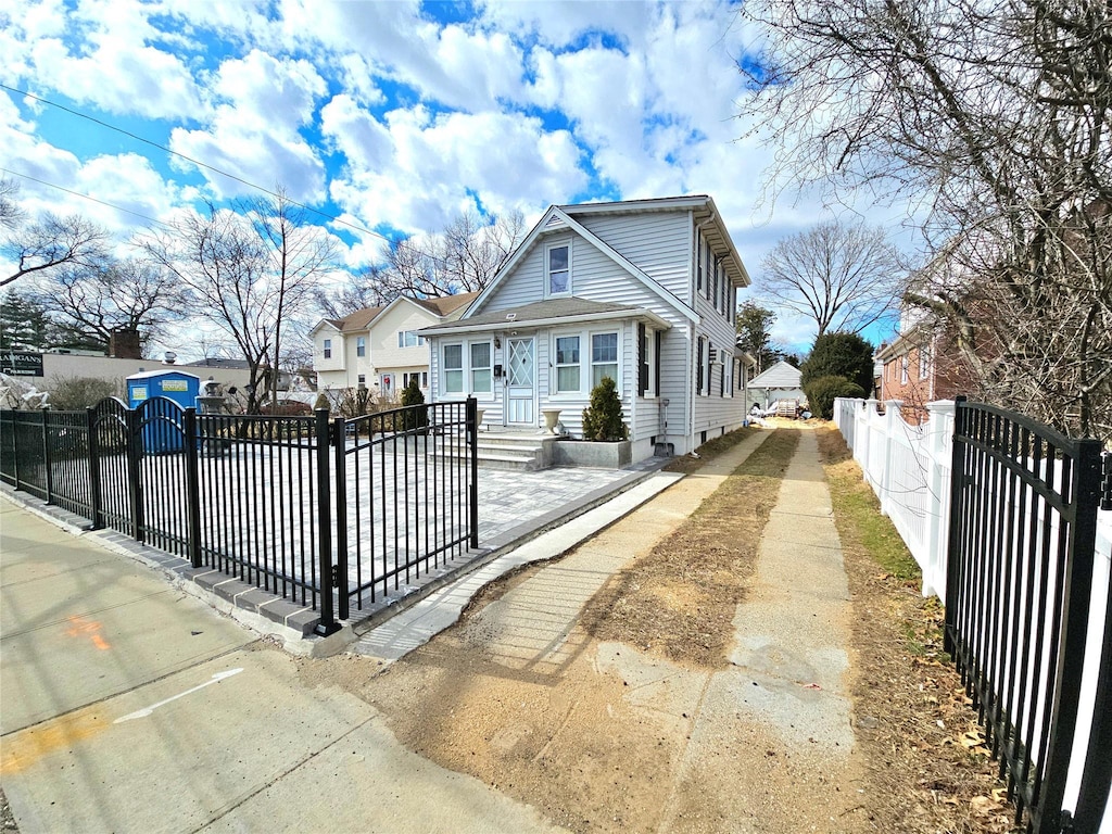 bungalow-style home featuring a fenced front yard and a gate