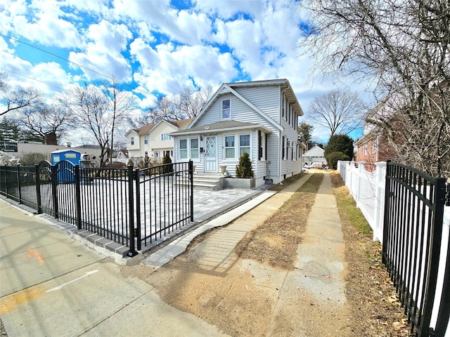 bungalow-style home featuring a fenced front yard and a gate