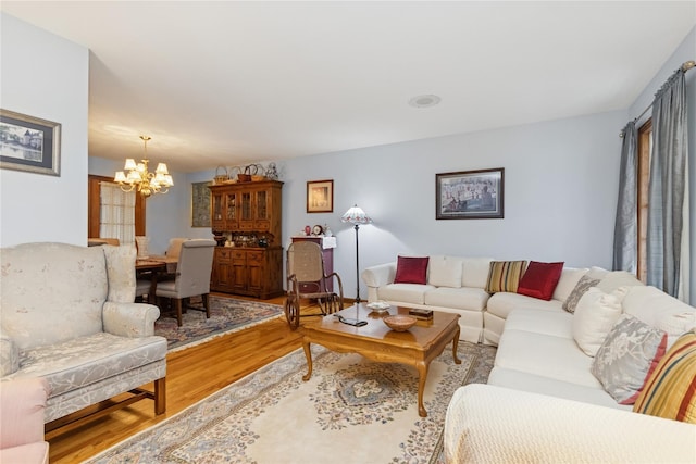 living area with an inviting chandelier and wood finished floors