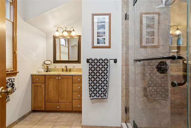 full bathroom featuring baseboards, a stall shower, vanity, and tile patterned flooring