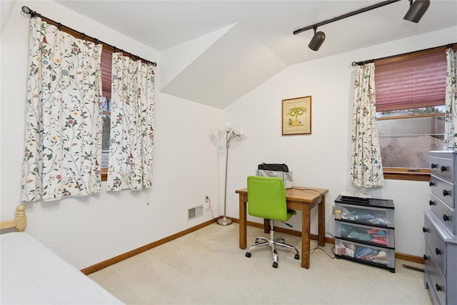 office space with visible vents, carpet floors, baseboards, and vaulted ceiling