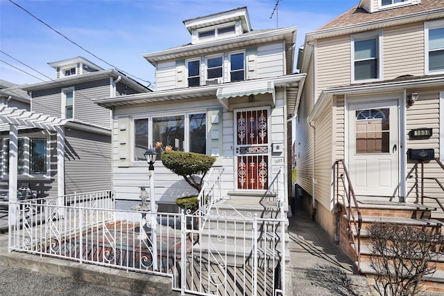 american foursquare style home with fence