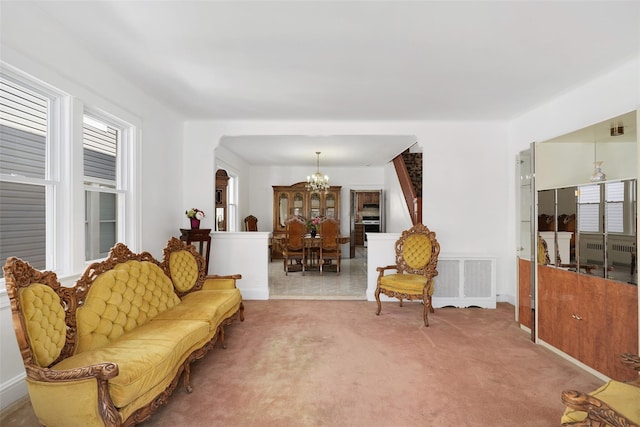 living area with light colored carpet and a notable chandelier