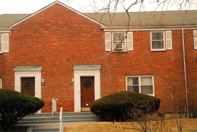 view of front of home with brick siding and cooling unit