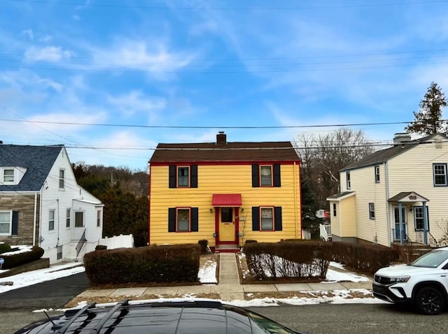 view of front facade featuring a chimney