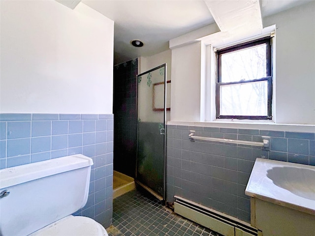 bathroom with a stall shower, toilet, a wainscoted wall, vanity, and a baseboard heating unit