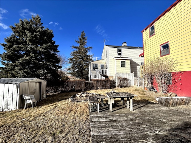 view of yard with a storage unit, an outdoor structure, and fence