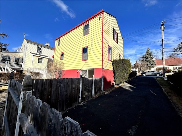 view of home's exterior with fence