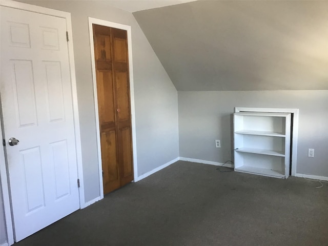 additional living space featuring lofted ceiling and baseboards