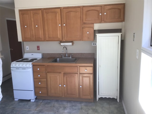 kitchen with electric range, a sink, and brown cabinets