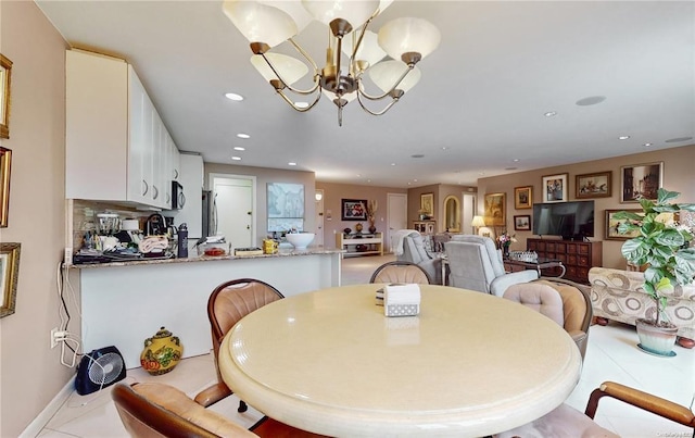 dining space with light tile patterned floors, baseboards, a chandelier, and recessed lighting