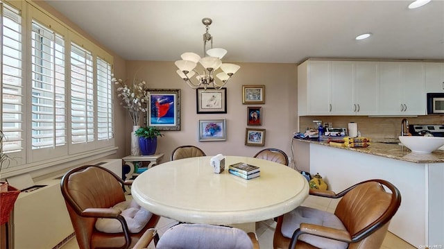 dining space featuring an inviting chandelier