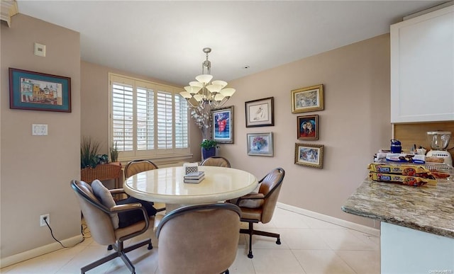 dining area featuring baseboards, a notable chandelier, and light tile patterned flooring