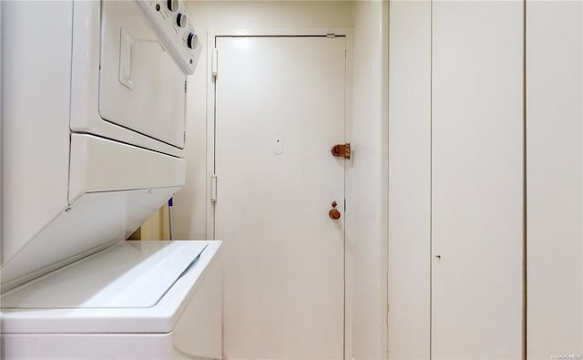 clothes washing area with laundry area and stacked washer and clothes dryer