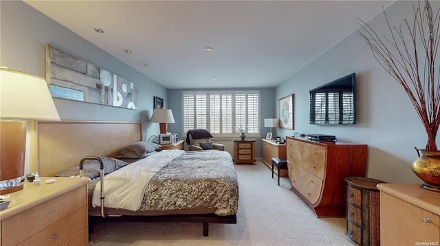 bedroom featuring light colored carpet