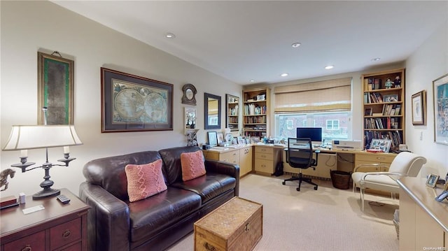 office space with built in shelves, recessed lighting, and light colored carpet