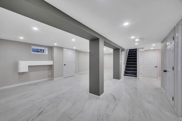 finished basement with marble finish floor, recessed lighting, stairs, and baseboards