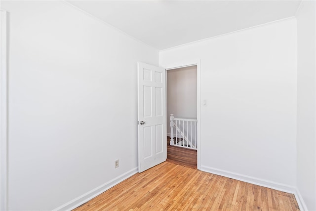 unfurnished room featuring light wood-type flooring and baseboards