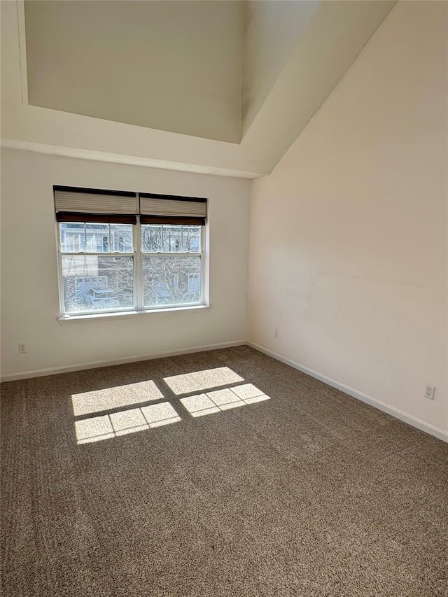 unfurnished room with carpet flooring and baseboards