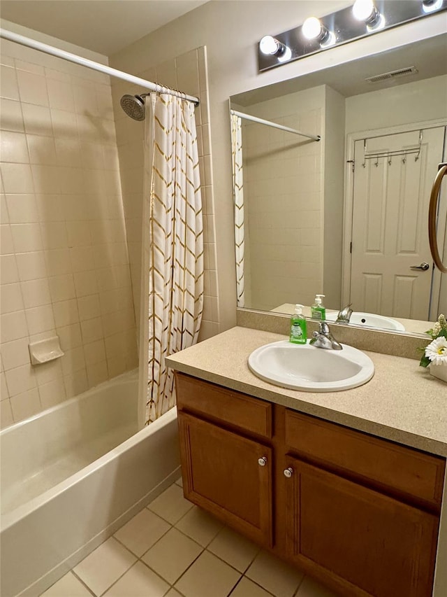 bathroom with tile patterned floors, visible vents, vanity, and shower / tub combo