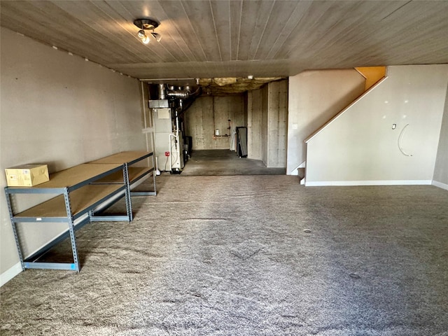 hallway with stairs, heating unit, and carpet floors