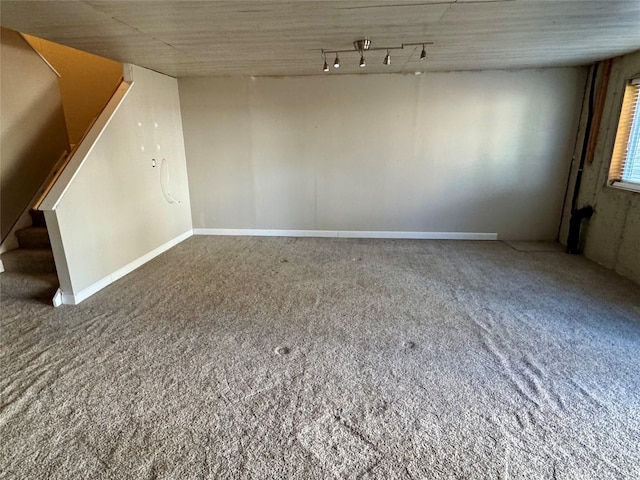 interior space featuring stairway, carpet flooring, and track lighting