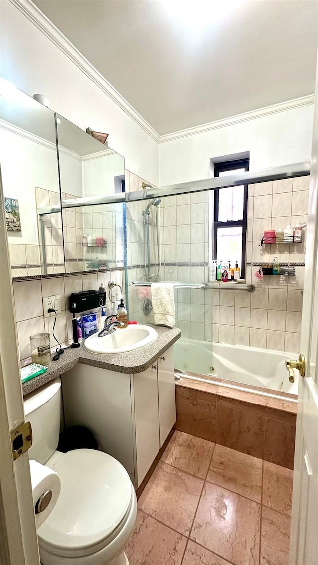 bathroom featuring tiled shower / bath combo, tile walls, toilet, and crown molding