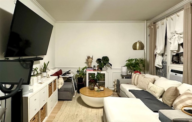 living area with light wood-type flooring, wainscoting, crown molding, and cooling unit