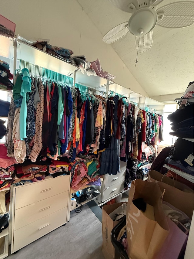 spacious closet with a ceiling fan and vaulted ceiling