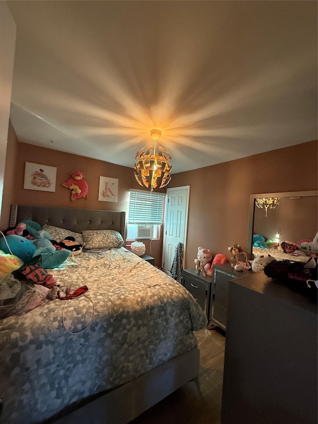 bedroom featuring cooling unit and wood finished floors