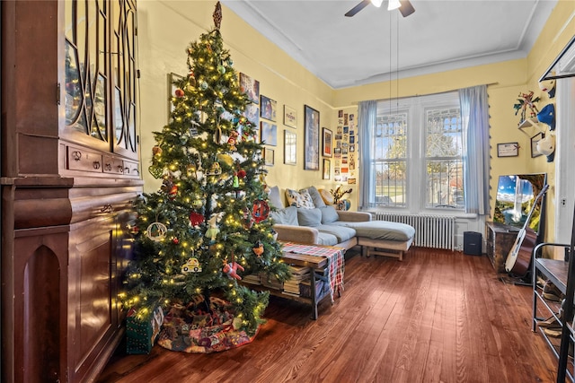 interior space with hardwood / wood-style floors, a ceiling fan, and radiator