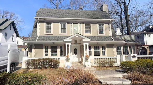 82-37 Austin St, Kew Gardens, NY 11415 - view of front of home featuring stucco siding, fence, roof with shingles, covered porch, and a chimney