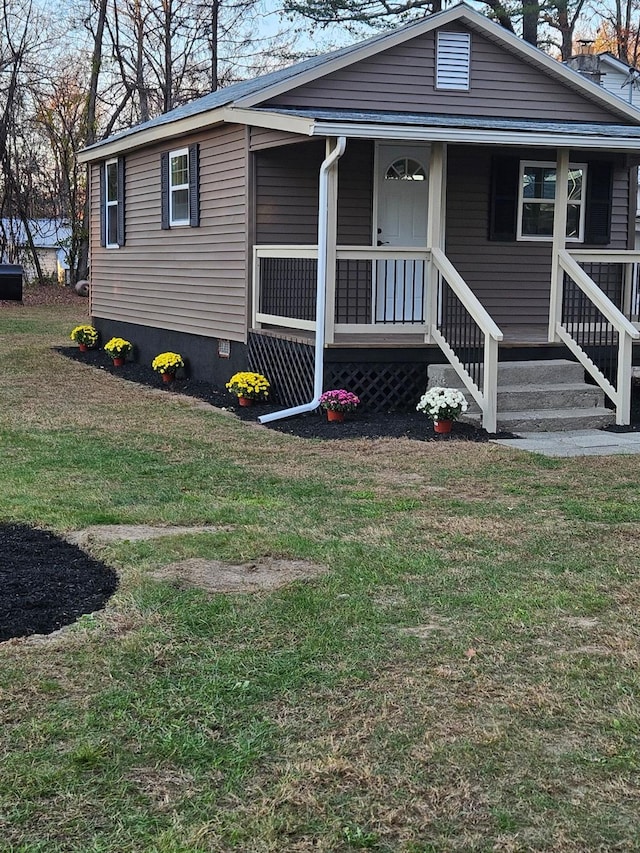 view of front of home with covered porch and a front yard