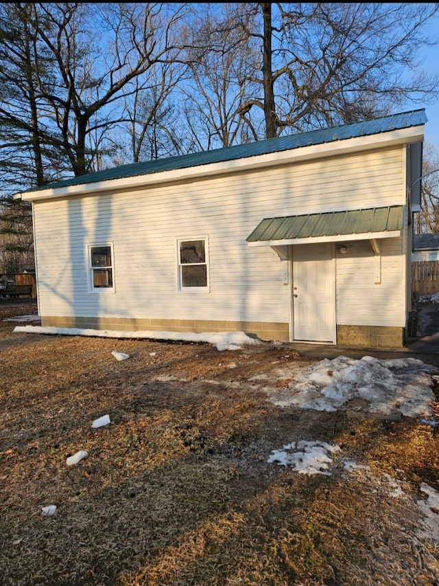 view of side of property featuring metal roof