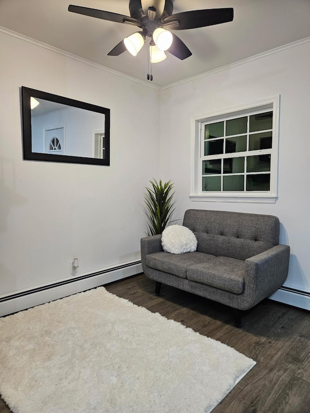 living area with ceiling fan, wood finished floors, baseboard heating, and ornamental molding