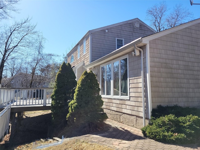 view of home's exterior featuring a wooden deck