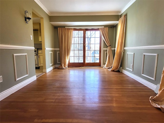 interior space featuring ornamental molding, a decorative wall, and dark wood-style flooring