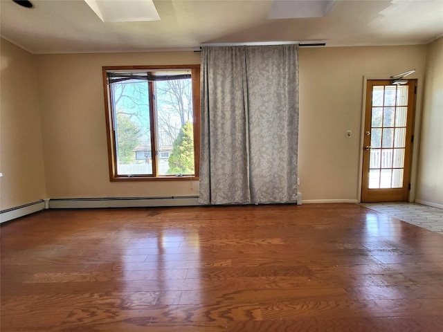 unfurnished room featuring crown molding, wood finished floors, and baseboards