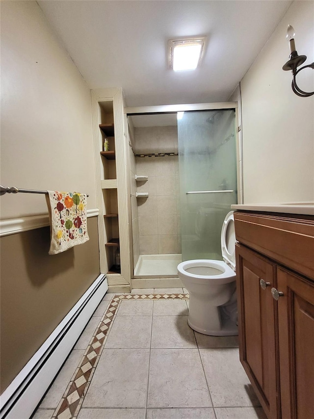 bathroom with toilet, baseboard heating, a stall shower, vanity, and tile patterned floors