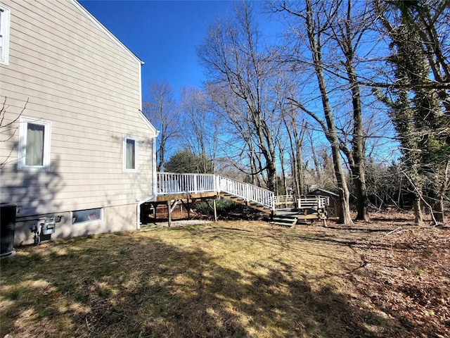 view of yard featuring a deck and stairs