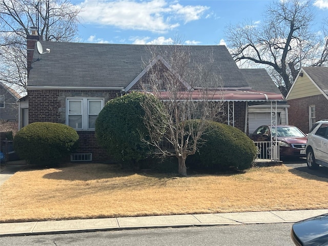 view of front of property with a garage, brick siding, decorative driveway, and a front yard