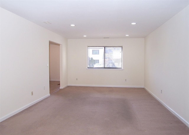 unfurnished room featuring recessed lighting and baseboards