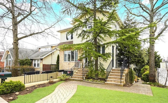 view of front of house with brick siding and a fenced front yard