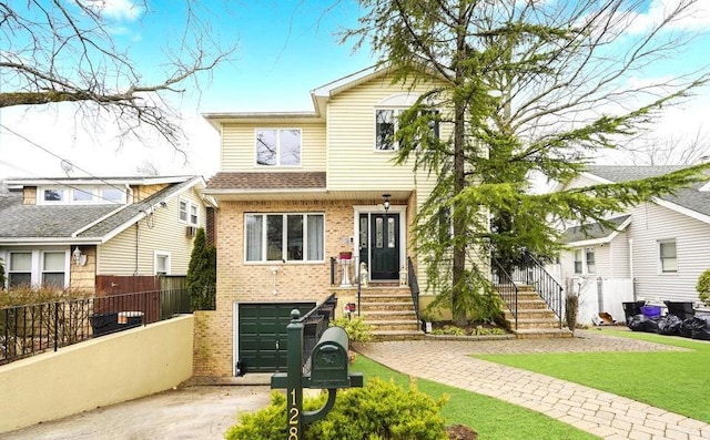 view of front of house featuring driveway, an attached garage, fence, and brick siding