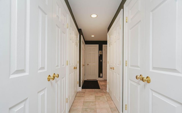 hallway with recessed lighting and light tile patterned floors